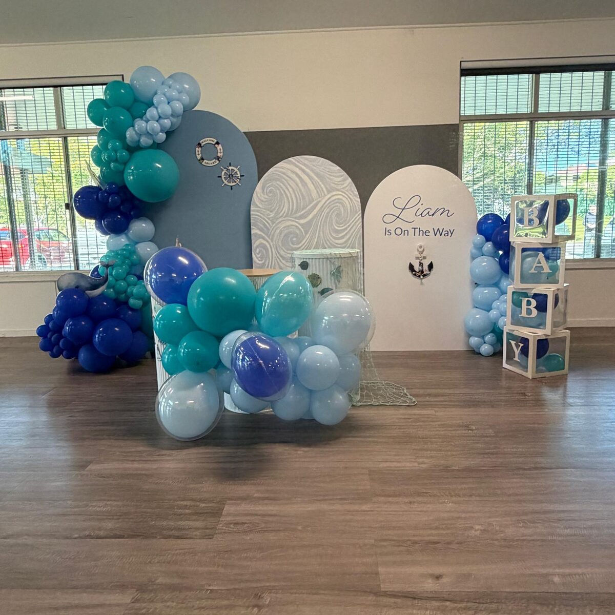 Nautical baby shower with blue and teal garland, baby letter boxes